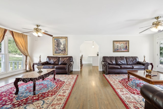 living room featuring wood-type flooring and ceiling fan