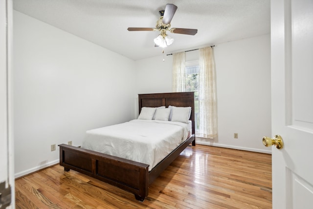 bedroom featuring light hardwood / wood-style flooring and ceiling fan