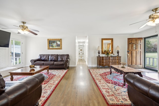 living room with crown molding, hardwood / wood-style floors, and ceiling fan