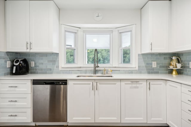 kitchen with sink, white cabinetry, and stainless steel dishwasher