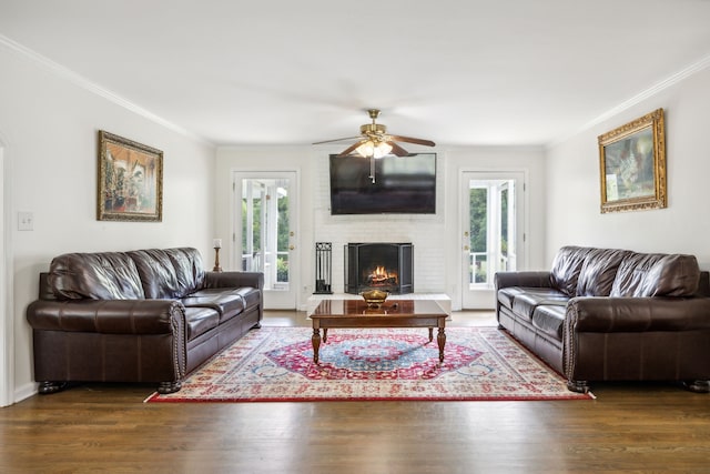 living room featuring plenty of natural light, dark hardwood / wood-style floors, and ornamental molding