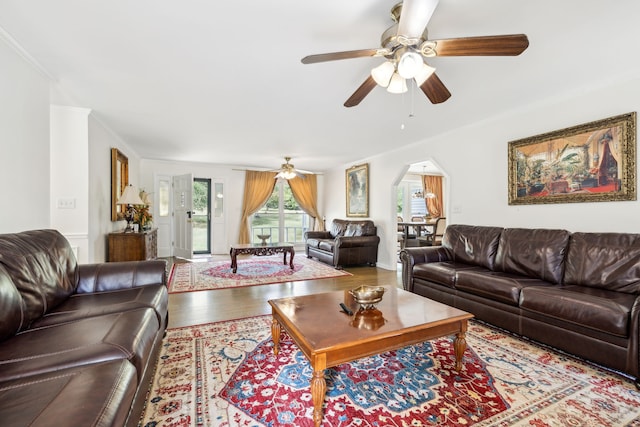 living room with ceiling fan, crown molding, and hardwood / wood-style floors