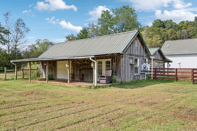 exterior space featuring a yard and an outbuilding