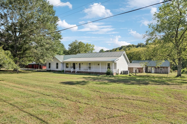 ranch-style house featuring a front yard, a porch, and central AC