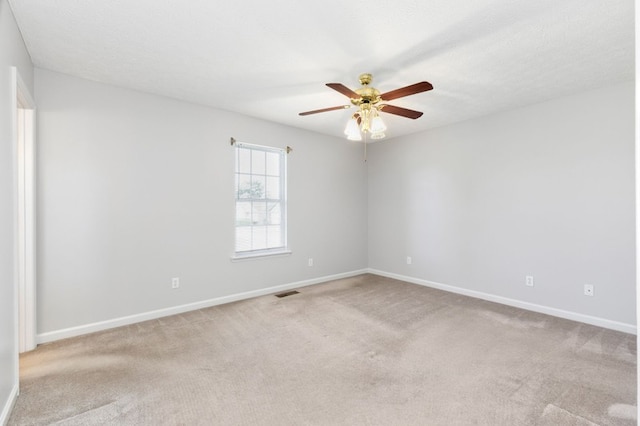 empty room featuring light carpet and ceiling fan