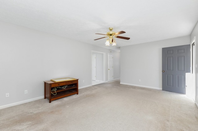 unfurnished room featuring ceiling fan and light colored carpet