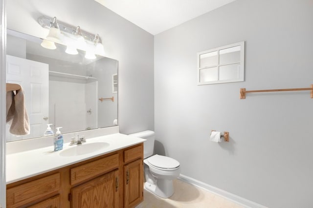 bathroom featuring walk in shower, vanity, and toilet