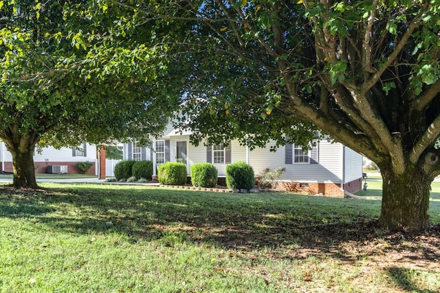 obstructed view of property with a front yard