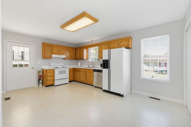 kitchen featuring plenty of natural light, sink, and white appliances