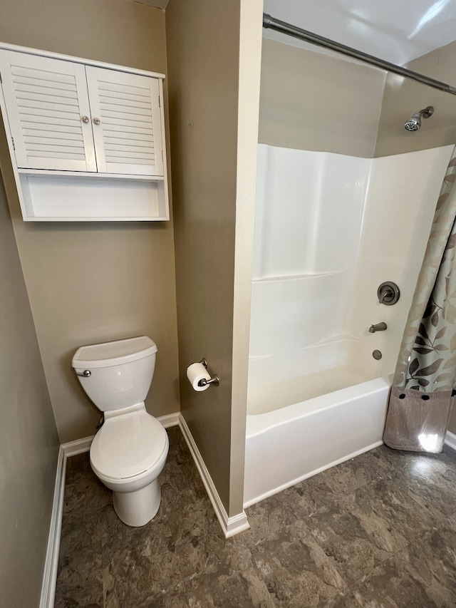 bathroom with shower / tub combo and toilet