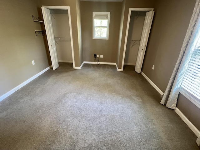 1518 Matlock Dr, Chapmansboro, TN 37035 - unfurnished bedroom featuring carpet floors, baseboards, and multiple closets