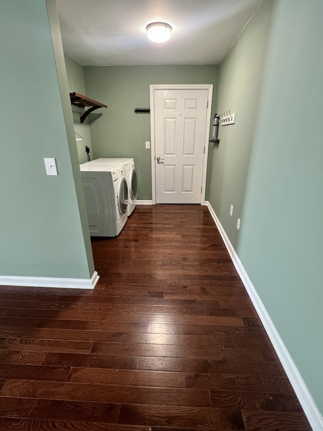 clothes washing area with separate washer and dryer and dark hardwood / wood-style floors