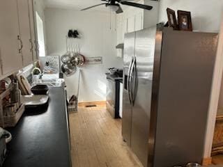 kitchen with ceiling fan, appliances with stainless steel finishes, and light hardwood / wood-style floors