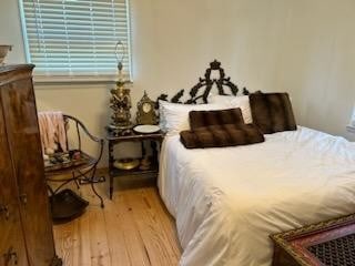 bedroom with hardwood / wood-style flooring