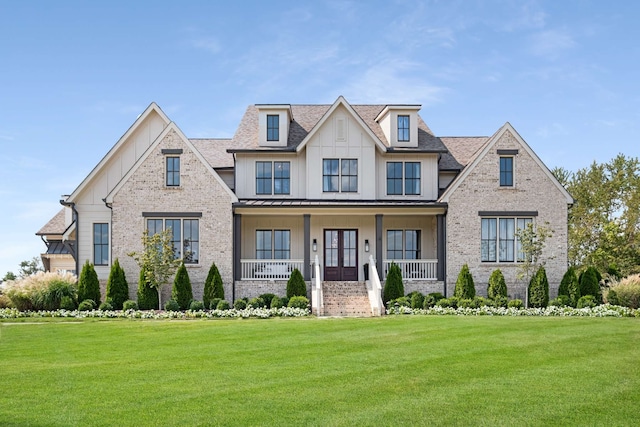 view of front of property with a porch and a front lawn