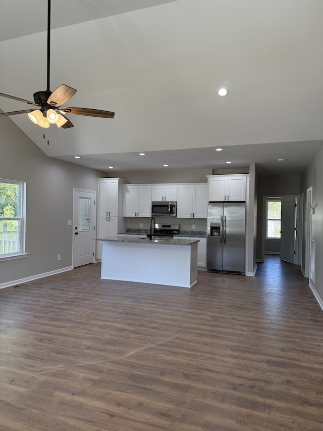 kitchen with a wealth of natural light, white cabinetry, a kitchen island with sink, and stainless steel appliances