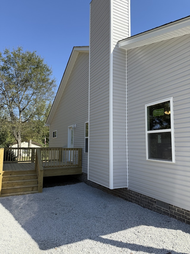 view of side of property with a wooden deck