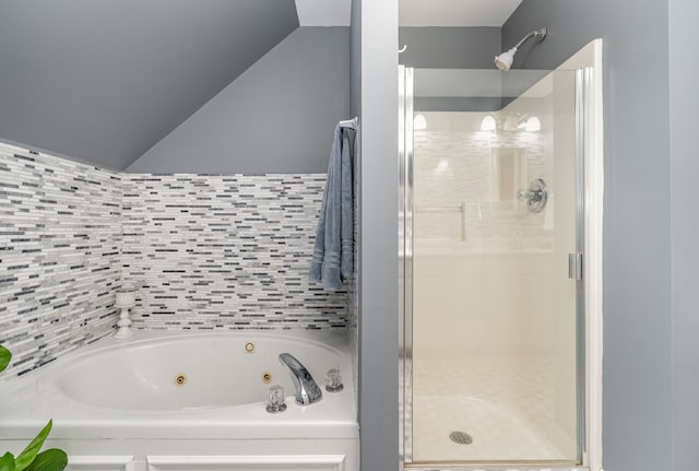 bathroom featuring lofted ceiling and independent shower and bath