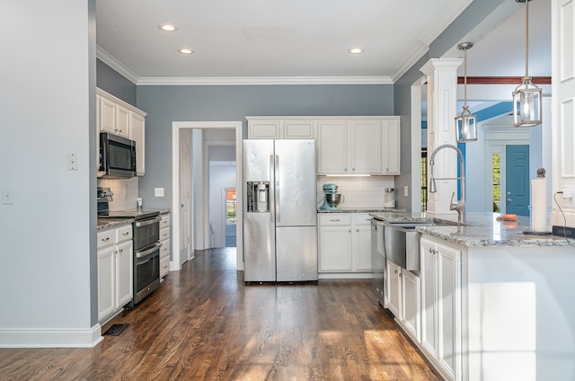 kitchen with hanging light fixtures, white cabinetry, appliances with stainless steel finishes, dark hardwood / wood-style floors, and light stone countertops