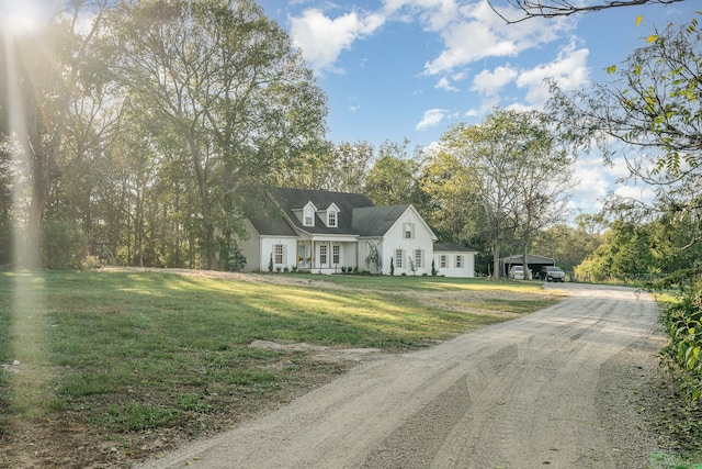 cape cod house featuring a front yard