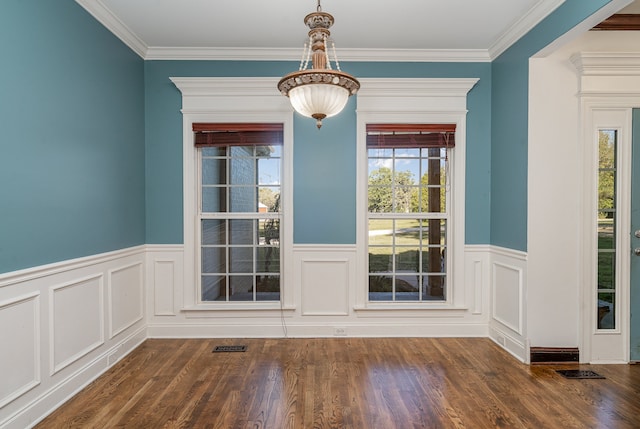 interior space with dark hardwood / wood-style floors, ornamental molding, and a healthy amount of sunlight