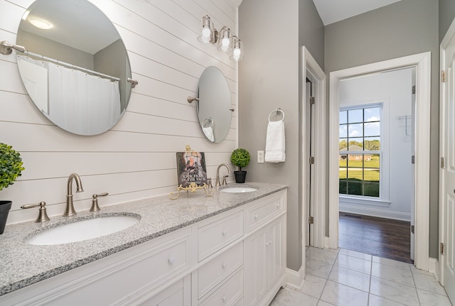 bathroom with wooden walls, hardwood / wood-style flooring, and vanity