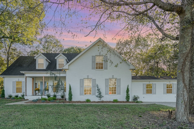 view of front facade with a yard and a porch