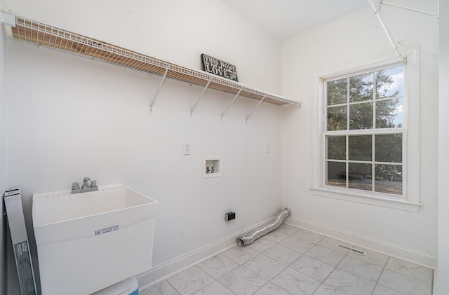 clothes washing area featuring washer hookup