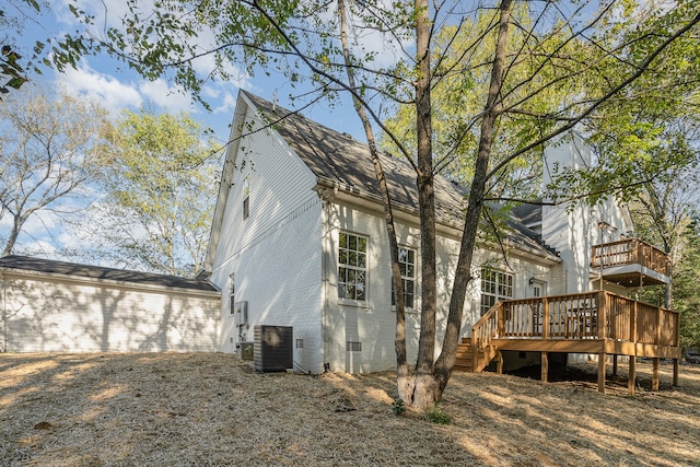 back of property featuring a deck and central air condition unit