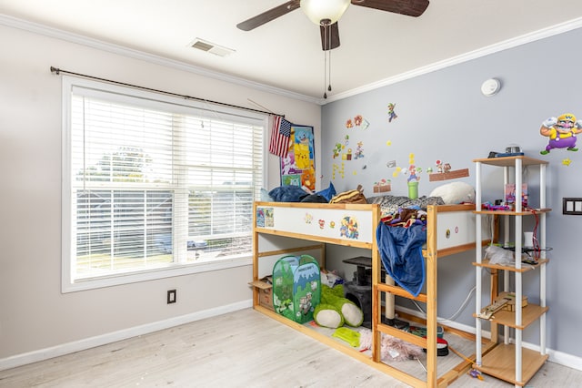 bedroom featuring crown molding, light hardwood / wood-style flooring, and ceiling fan