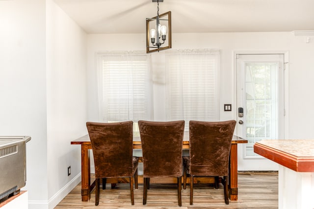 dining space with a chandelier and light wood-type flooring