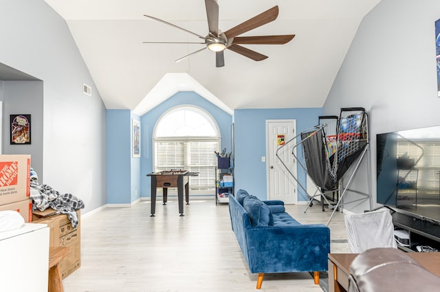 living room featuring ceiling fan, lofted ceiling, and light wood-type flooring