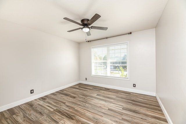 spare room featuring hardwood / wood-style floors and ceiling fan