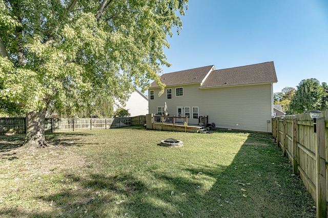 view of yard with an outdoor fire pit and a deck