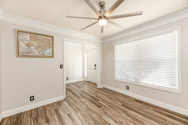 empty room with ornamental molding, light hardwood / wood-style flooring, and ceiling fan