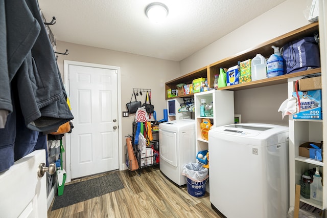 laundry area with independent washer and dryer, a textured ceiling, and hardwood / wood-style floors