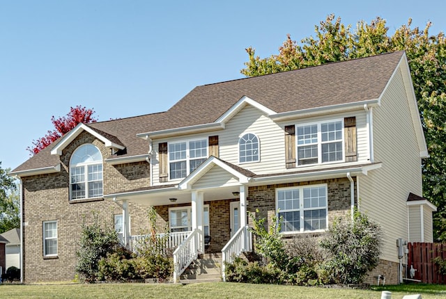 view of front facade with covered porch and a front lawn