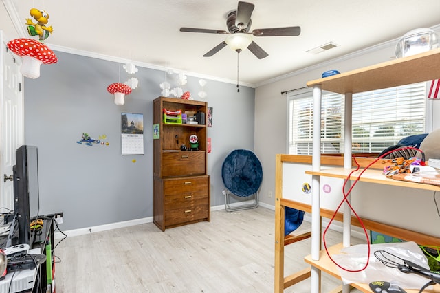 bedroom featuring crown molding, light hardwood / wood-style flooring, and ceiling fan