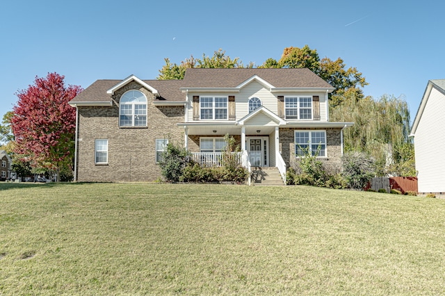 view of front facade with a front yard and covered porch