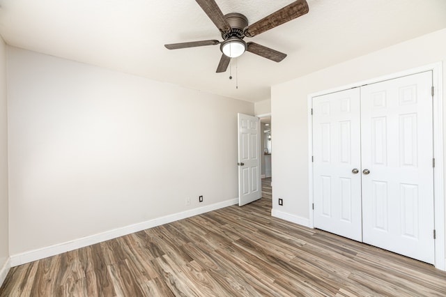 unfurnished bedroom featuring a closet, light wood-type flooring, and ceiling fan