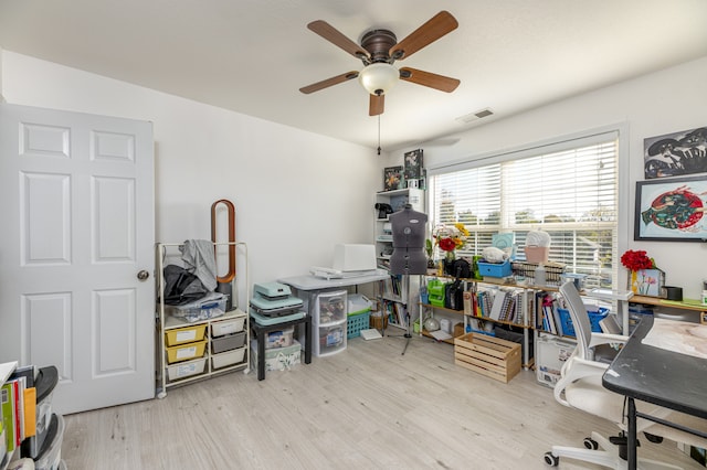 home office featuring light hardwood / wood-style floors and ceiling fan