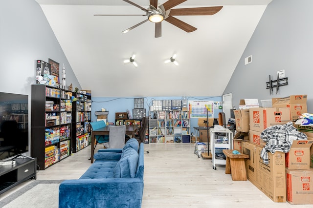 living room featuring ceiling fan, lofted ceiling, and light wood-type flooring