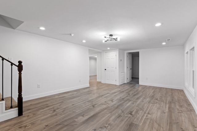 interior space featuring light hardwood / wood-style floors and a chandelier