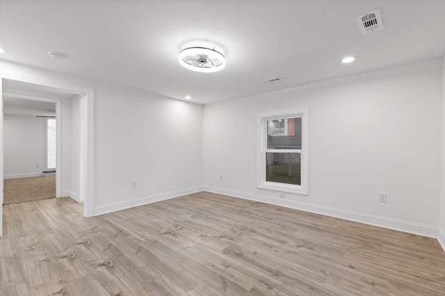 empty room with light hardwood / wood-style flooring