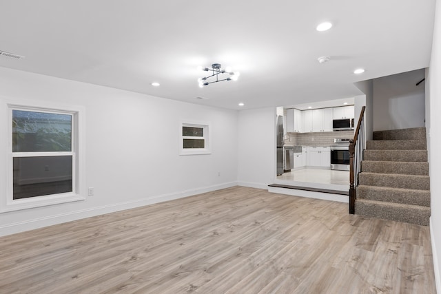 unfurnished living room featuring light wood-type flooring