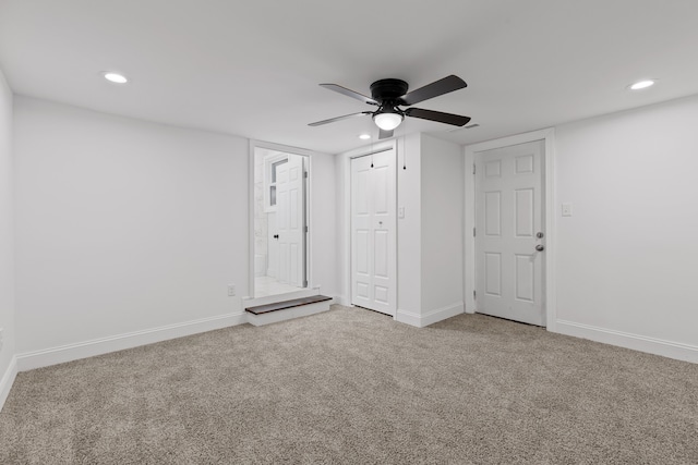 interior space with ceiling fan and carpet floors