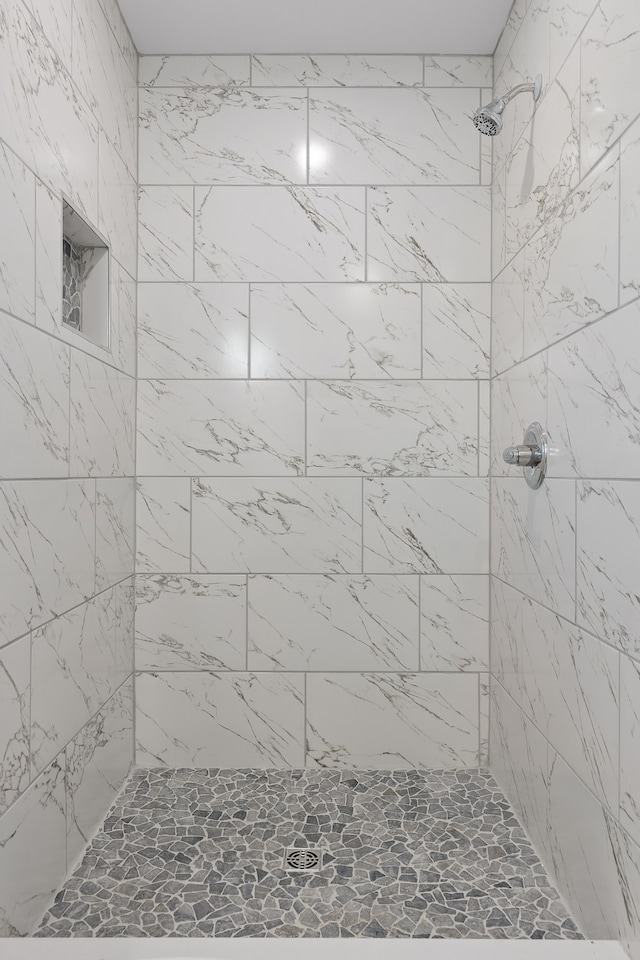 bathroom with tiled shower