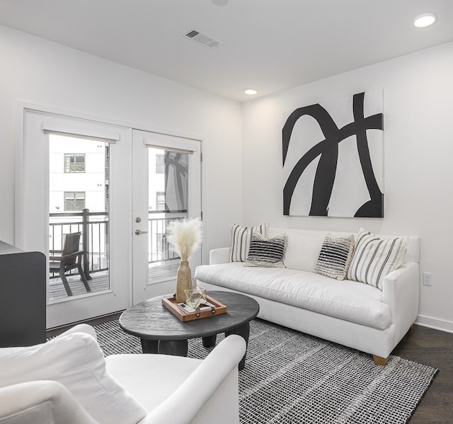 living room featuring dark wood-type flooring and french doors