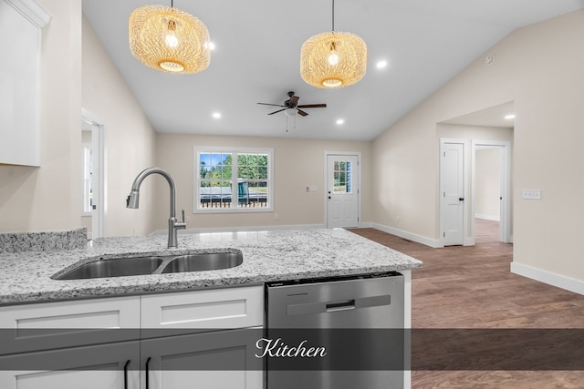 kitchen with lofted ceiling, dark wood-type flooring, white cabinetry, and stainless steel dishwasher