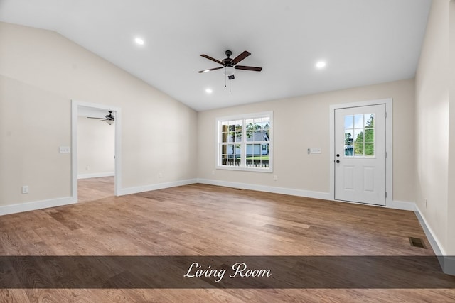 foyer entrance featuring wood-type flooring, lofted ceiling, plenty of natural light, and ceiling fan